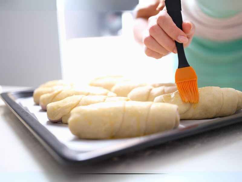  Brushing the Tops of Each Knot With the Mixture.