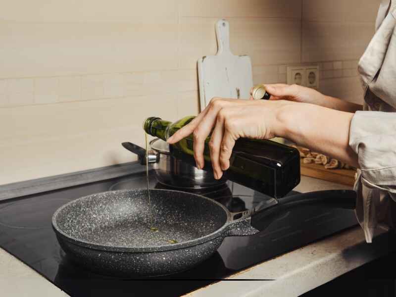 Pouring Olive Oil in Skillet