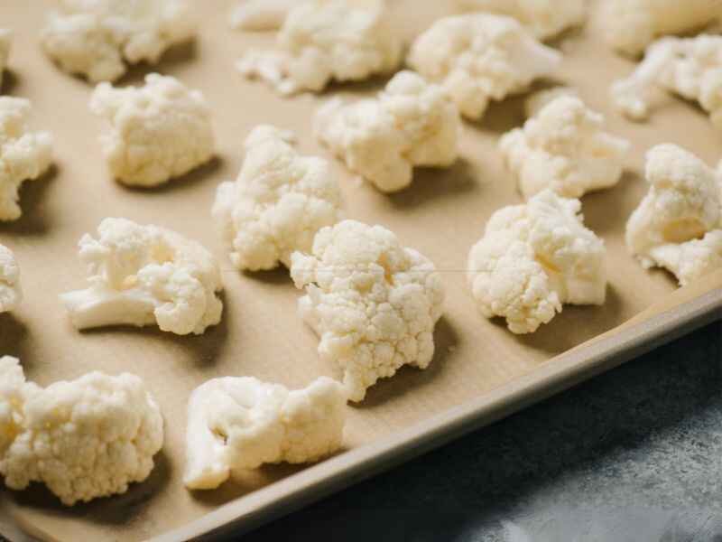 Placing Coated Cauliflower Florets Over the Baking Sheet