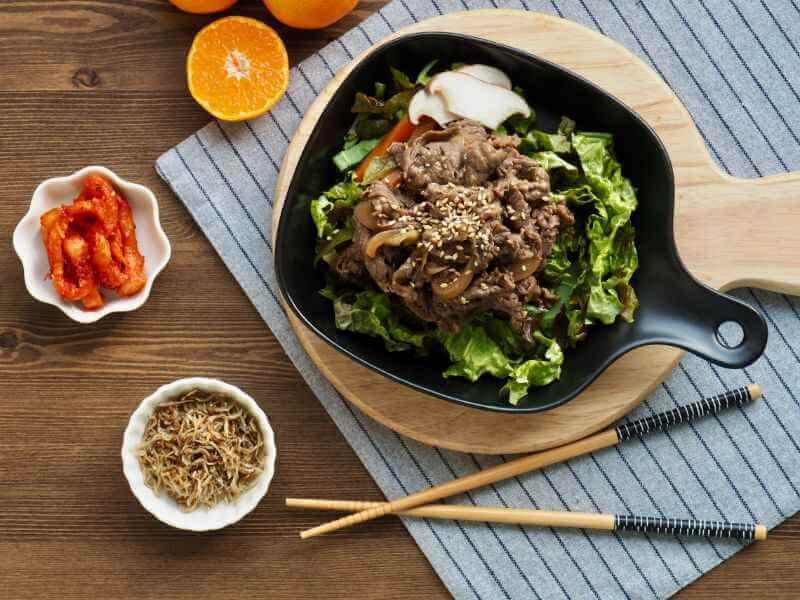 Instant pot Korean Beef Bulgogi Bowls served with kimchi and shredded veggies. 