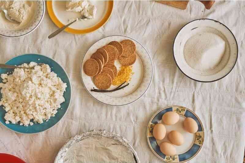 Cookies, sugar, eggs, and other ingredients for cheesecake