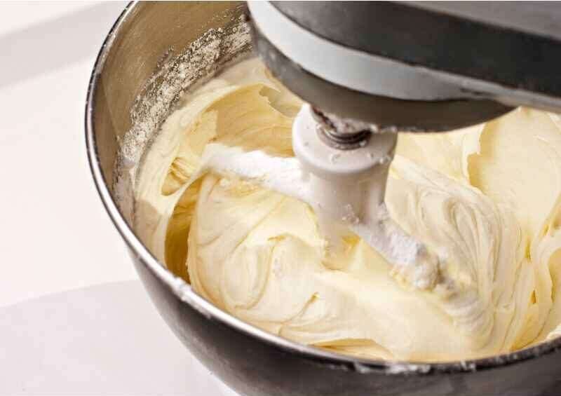 White frosting in a mixing bowl