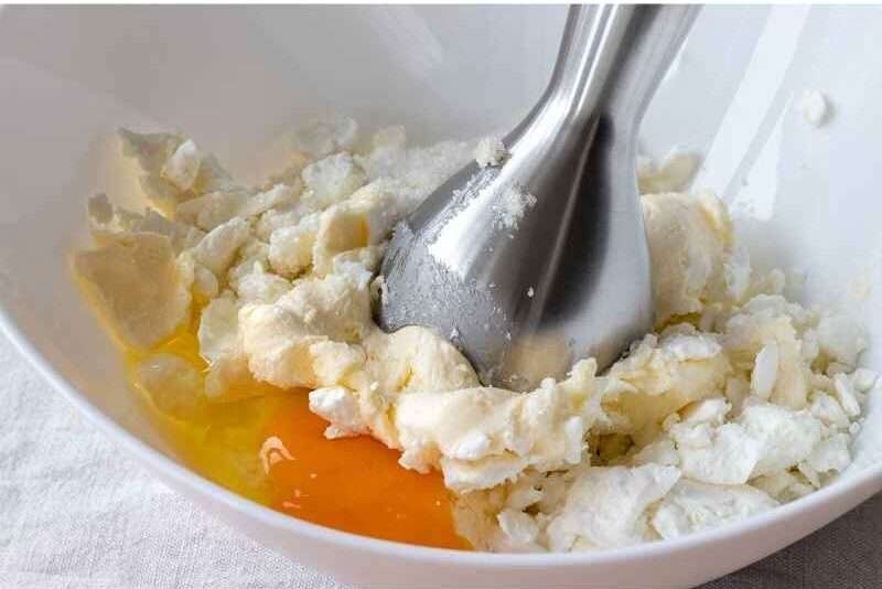 Mixing eggs and cheese in a bowl