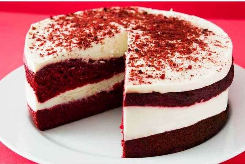 A sliced and the rest of the red velvet cheesecake