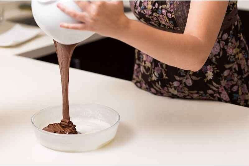 pouring melted chocolate in a bowl