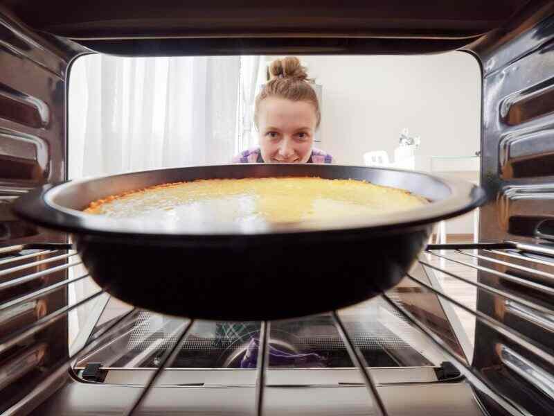 A cheesecake in an oven