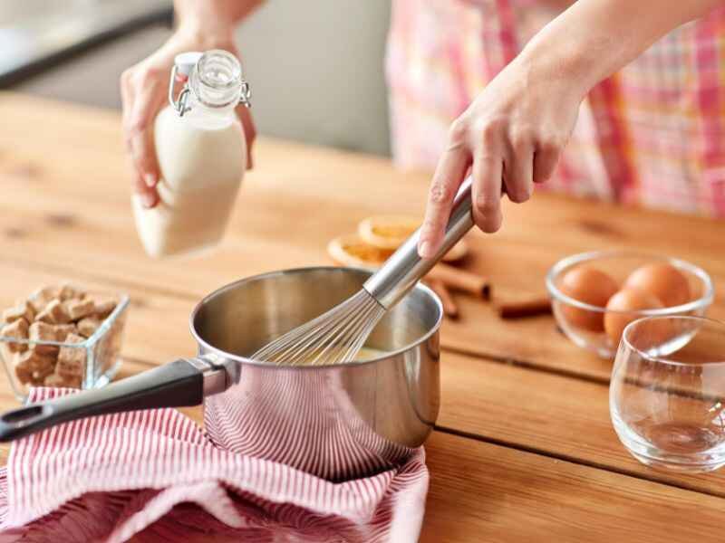 Woman Whisking Egg and Almond Milk Together. 