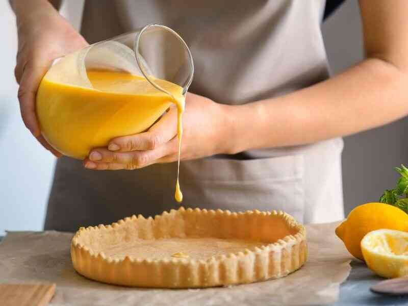 Putting the crumbly dough into the baking pan