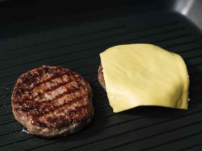 Place a slice of cheese on top of the patties