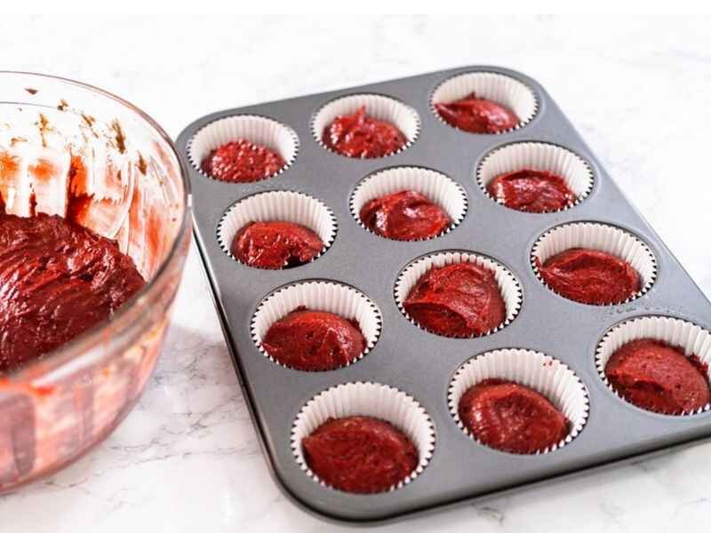 Scope the batter evenly into each cupcake well